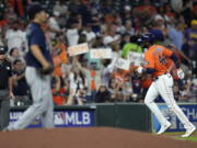 Houston Astros' Yordan Alvarez (44) runs the bases after hitting a two-run home run off Seattle Mariners starting pitcher Yusei Kikuchi, left, during the third inning of a baseball game Friday, Aug. 20, 2021, in Houston. (AP Photo/David J.