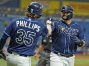 The Rays' Mike Zunino, right, celebrates with Brett Phillips after his solo home run off Seattle's Drew Steckenrider.