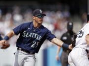 Seattle Mariners shortstop Dylan Moore (25) tags out New York Yankees' DJ LeMahieu during the sixth inning of a baseball game on Saturday, Aug. 7, 2021, in New York.