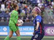 OL Reign forward Megan Rapinoe, right, celebrates as Portland Thorns goalkeeper Bella Bixby, left, holds the ball after Rapinoe scored a goal on a penalty kick during the first half of an NWSL soccer match, Sunday, Aug. 29, 2021, in Seattle. (AP Photo/Ted S.