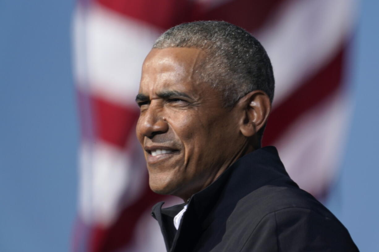 FILE - In this Nov. 2, 2020 file photo, former President Barack Obama speaks at a rally as he campaigns for Democratic presidential candidate former Vice President Joe Biden at Turner Field in Atlanta. Obama has scaled down his 60th birthday bash due to the surge in the delta variant of the coronavirus. A spokeswoman says the party planned for this weekend at his home on Martha's Vineyard is now limited to family and close friends. Obama, who turned 60 on Wednesday, had been criticized for planning a big celebration during a pandemic.