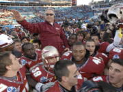 FILE - In this Jan. 1, 2010, file photo, Florida State head coach Bobby Bowden is carried on the shoulders of his players after their 33-21 win over West Virginia in the Gator Bowl NCAA college football game in Jacksonville, Fla. Bowden, the folksy Hall of Fame coach who built Florida State into an unprecedented college football dynasty, has died. He was 91. Bobby's son, Terry, confirmed to The Associated Press that his father died at home in Tallahassee, Fla., surrounded by family early Sunday, Aug. 8, 2021.