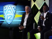 Pac-12 Commissioner George Kliavkoff, center, and Senior Associate Commissioner for Football Operations Merton Hanks field questions during the Pac-12 Conference NCAA college football Media Day Tuesday, July 27, 2021, in Los Angeles.