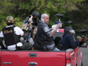 Tusitala "Tiny" Toese, a member of the far-right group Proud Boys, fires paintball rounds at anti-fascist protesters as they depart from their rally on Sunday, Aug. 22, 2021, in Portland, Ore.