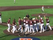 The Ridgefield Raptors await John Peck at home plate after his game-winning home run in the 11th inning against the Walla Walla Sweets on Sunday at Ridgefield Outdoor Recreation Complex.