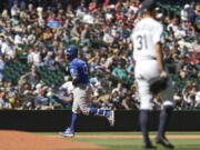 Kansas City Royals' Salvador Perez rounds third after hitting a two-run home run as Seattle Mariners starting pitcher Tyler Anderson looks on during the fifth inning of a baseball game Saturday, Aug. 28, 2021, in Seattle.