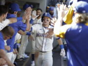 Seattle Mariners' Jarred Kelenic celebrates in the dugout after hitting a solo home run during the sixth inning of a baseball game against the Kansas City Royals, Sunday, Aug. 29, 2021, in Seattle.