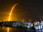 This long exposure photo shows the launch of a SpaceX Falcon 9 rocket on a resupply mission for NASA to the International Space Station from Pad 39A at Kennedy Space Center, seen from Merritt Island, Fla., Sunday, Aug. 29, 2021. The SpaceX shipment of ants, avocados and a human-sized robotic arm rocketed toward the International Space Station on Sunday.