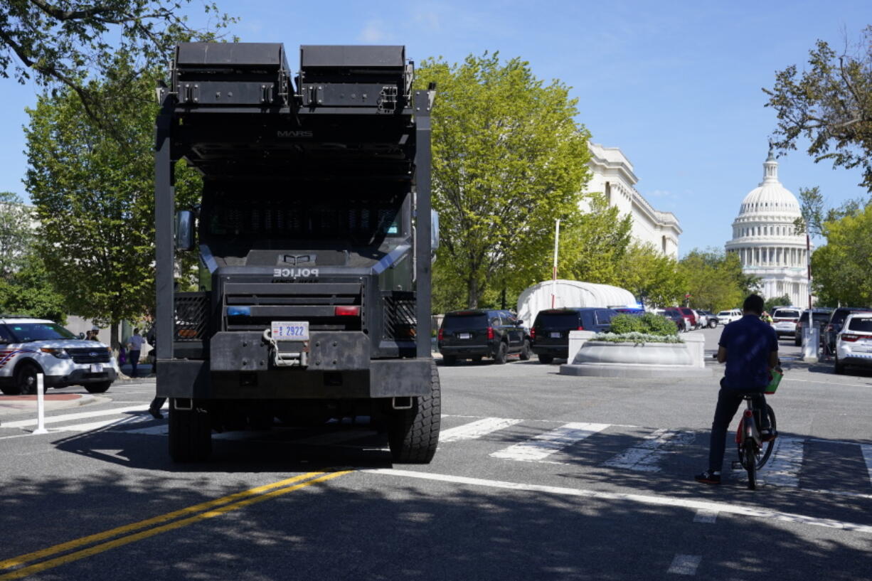 A police vehicle moves into an area near the U.S. Capitol and a Library of Congress building in Washington on Thursday, Aug. 19, 2021, as law enforcement officials investigate a report of a pickup truck containing an explosive device.