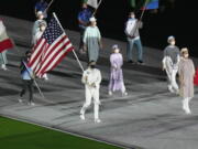 Kara Winger carries the flag of the United States of America during the closing ceremony of the 2020 Summer Olympics, Sunday in Tokyo, Japan.