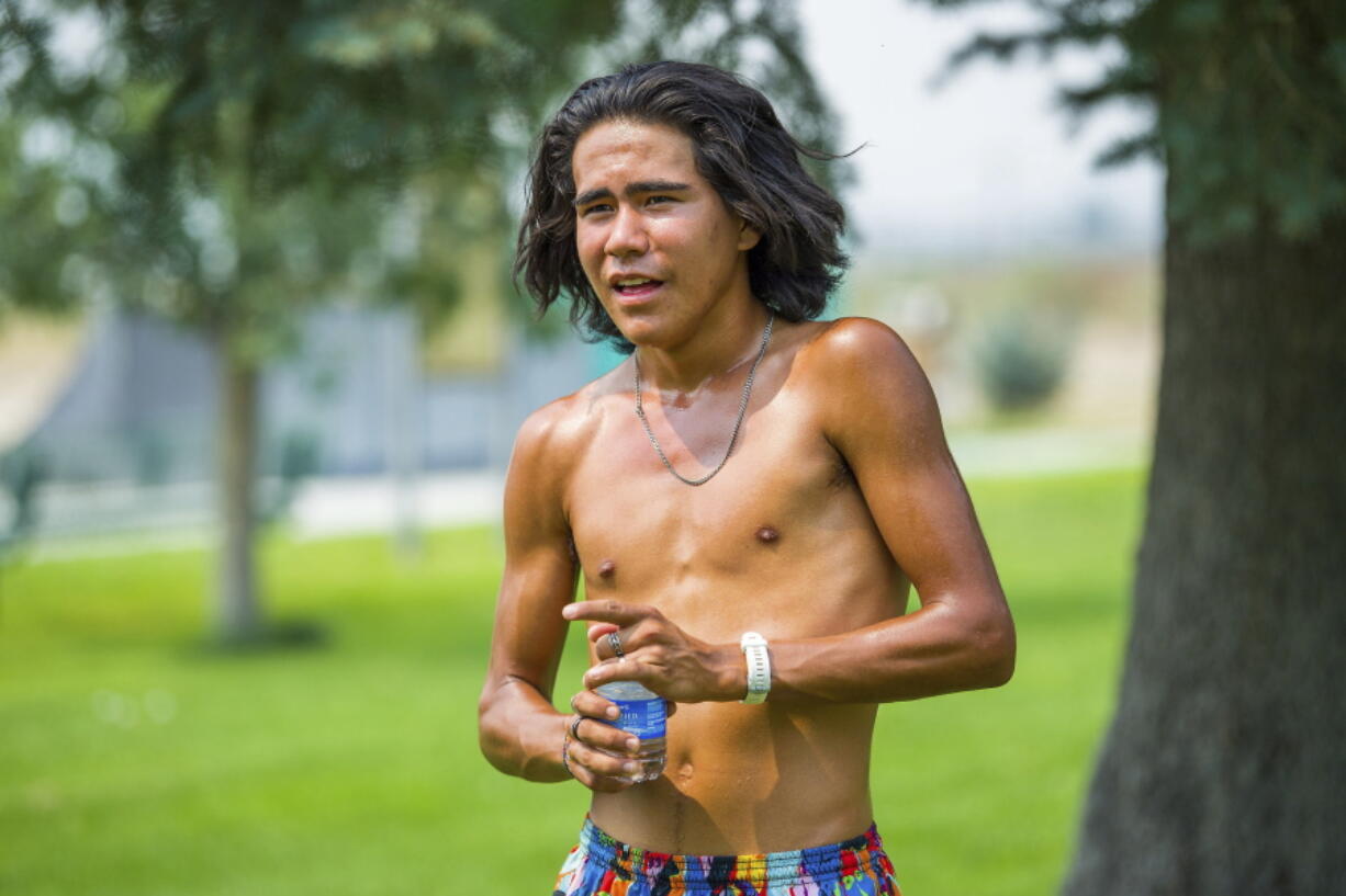 Ku Stevens catches his breath after finishing the Remembrance Run at Bernie Giron Park on the Yerington Paiute reservation in this photo taken on Aug. 15, 2021. Stevens made the 50-mile run over two days across the desert from Carson City in memory of his ancestors who taken from their families and forced to attend the Stewart Indian School there about a century ago.