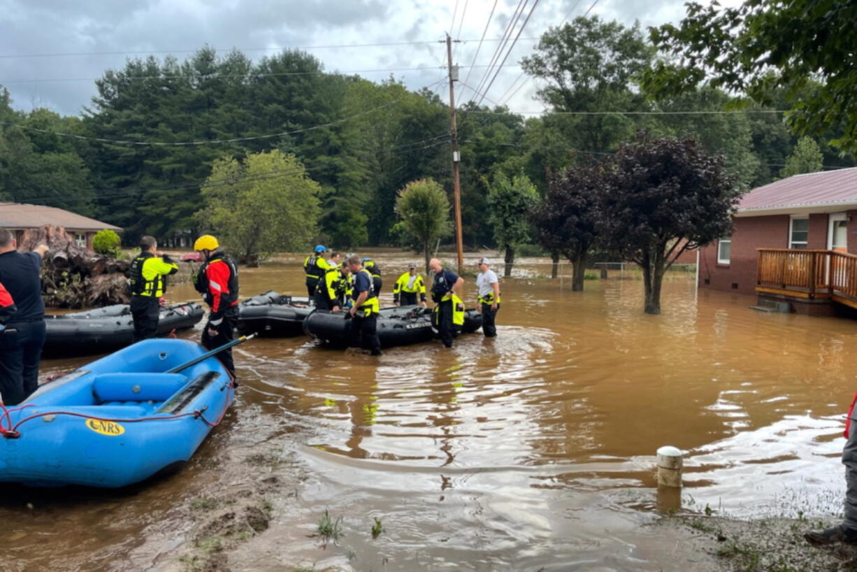 NCDOT workers assess damage to a bridge spanning the Pigeon River, Thursday, Aug. 19, 2021, in Bethel, N.C., after remnants from Tropical Storm Fred caused flooding in parts of Western North Carolina Tuesday. Search and rescue teams continue to search the area as 20 people are missing and 2 people were found dead.