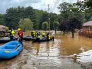 NCDOT workers assess damage to a bridge spanning the Pigeon River, Thursday, Aug. 19, 2021, in Bethel, N.C., after remnants from Tropical Storm Fred caused flooding in parts of Western North Carolina Tuesday. Search and rescue teams continue to search the area as 20 people are missing and 2 people were found dead.