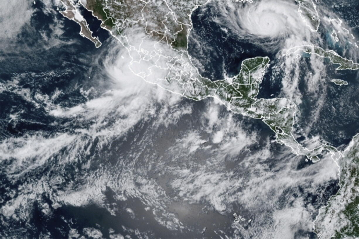 This image provided by the National Oceanic and Atmospheric Administration (NOAA) shows severe weather systems, Hurricane Nora, upper left, and Hurricane Ida, upper right, over the North American continent on Saturday, Aug. 28, 2021. Hurricane Nora is churning northward up Mexico's Pacific Coast toward the narrow Gulf of California, after making a sweep past the Puerto Vallarta area.