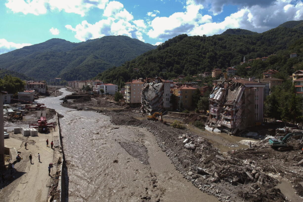 An aerial view of the city center in Bozkurt town of Kastamonu province, Turkey, Sunday, Aug. 15, 2021, after flooding. Turkey sent ships to help evacuate people and vehicles from a northern town on the Black Sea that was hard hit by flooding, as the death toll in the disaster rose Sunday to at least 62 and more people than that remained missing.