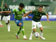 Timbers midfielder Sebastian Blanco, right, navigates around a Sounders defender during the Sounders' 6-2 win.