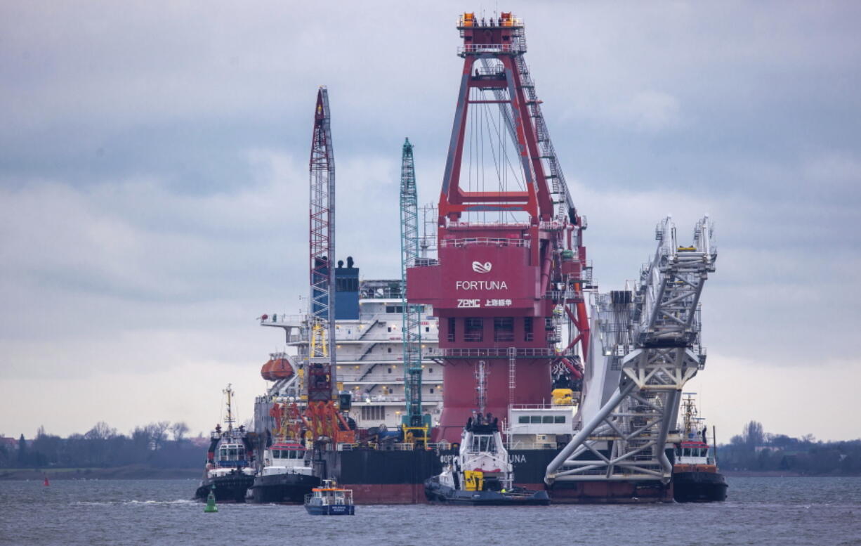 FILE - In this Jan. 14, 2021, file photo, tugboats get into position on the Russian pipe-laying vessel "Fortuna" in the port of Wismar, Germany. The special vessel is being used for construction work on the German-Russian Nord Stream 2 gas pipeline in the Baltic Sea. The Biden administration on Friday, Aug. 20, imposed new sanctions on three Russian ships and companies involved in constructing a controversial gas pipeline from Russia to Europe.