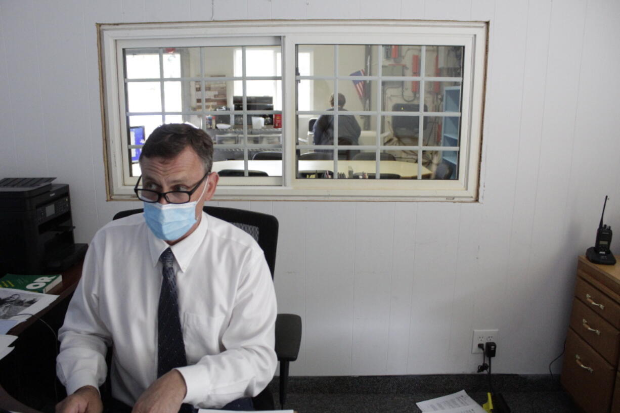 Alsea School District Superintendent Marc Thielman reads over the language of a federal disability anti-discrimination law Friday in his office on the school campus in Alsea, Ore.