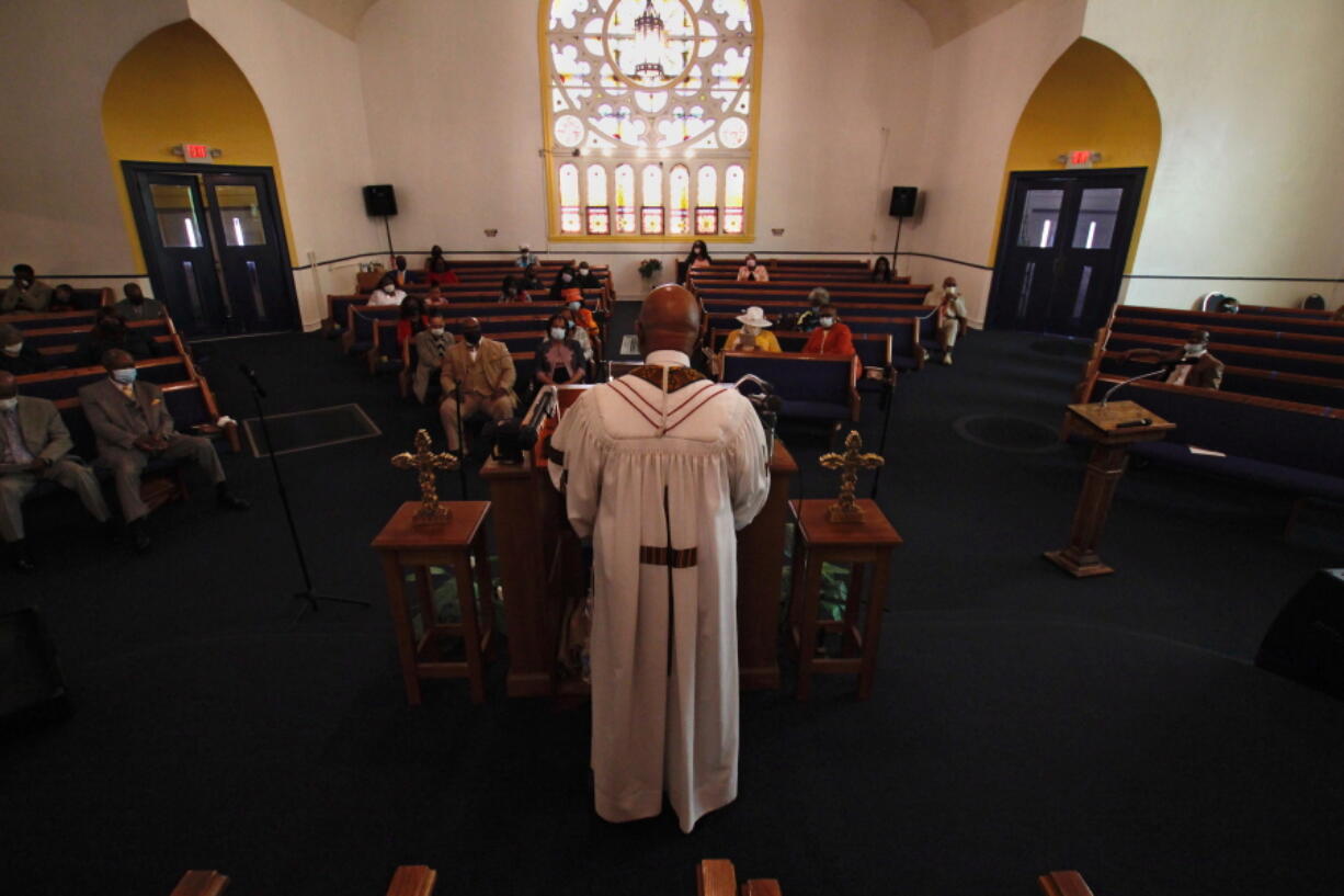 FILE - In this May 9, 2021 file photo, Rev. Joseph Jackson Jr. talks to his congregation at Friendship Missionary Baptist Church in Milwaukee during a service.  Health officials have an unsteady partner as they try to get more people vaccinated against COVID-19 in the Bible Belt: churches and pastors. Some preachers are praying for more inoculations and hosting vaccination clinics. Others are skirting the topic of vaccines or openly preaching against them in a region that's both deeply religious and reeling from a spike in cases.