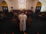 FILE - In this May 9, 2021 file photo, Rev. Joseph Jackson Jr. talks to his congregation at Friendship Missionary Baptist Church in Milwaukee during a service.  Health officials have an unsteady partner as they try to get more people vaccinated against COVID-19 in the Bible Belt: churches and pastors. Some preachers are praying for more inoculations and hosting vaccination clinics. Others are skirting the topic of vaccines or openly preaching against them in a region that's both deeply religious and reeling from a spike in cases.