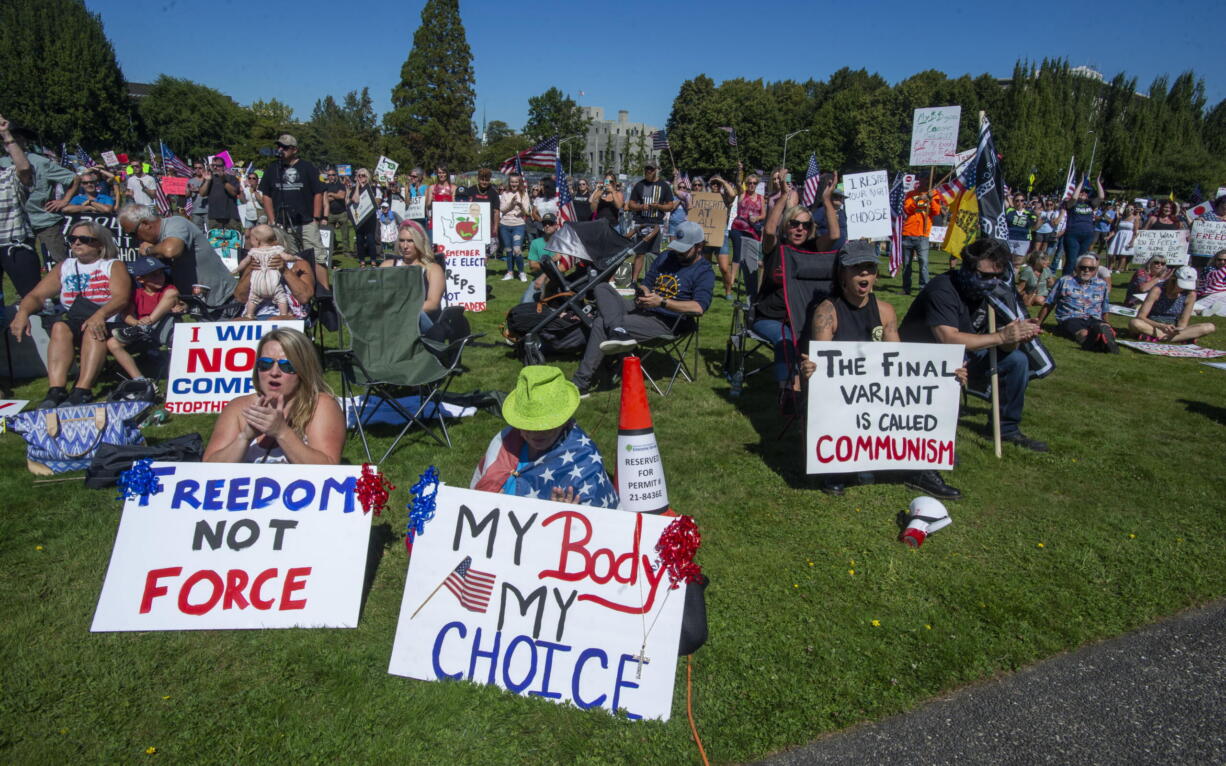 People gather outside the Capitol to protest Gov. Jay Inslee's vaccine mandate for state workers, Saturday, Aug. 28, 2021 in Olympia, Wash.