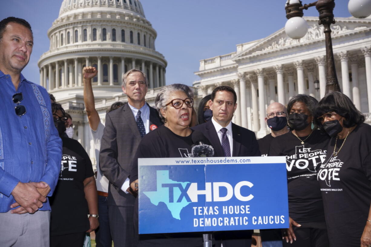 Rep. Senfronia Thompson, dean of the Texas House of Representatives, is joined by Sen. Jeff Merkley, D-Ore., left center, and other Texas Democrats, as they continue their protest of restrictive voting laws, at the Capitol in Washington, Friday, Aug. 6, 2021. (AP Photo/J.