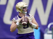 FILE - Washington Huskies quarterback Dylan Morris looks to pass during NCAA college football practice in Seattle, in this Friday, Aug. 6, 2021, file photo. Washington begins the 2021 season as one of the favorites in the Pac-12 North Division, while also trying to erase the bad taste of how last year ended when a COVID-19 outbreak brought a sudden end to an already truncated schedule.