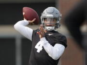 Washington State quarterback Jayden de Laura throws a pass on the first day fall practice in Pullman. (Ted S.