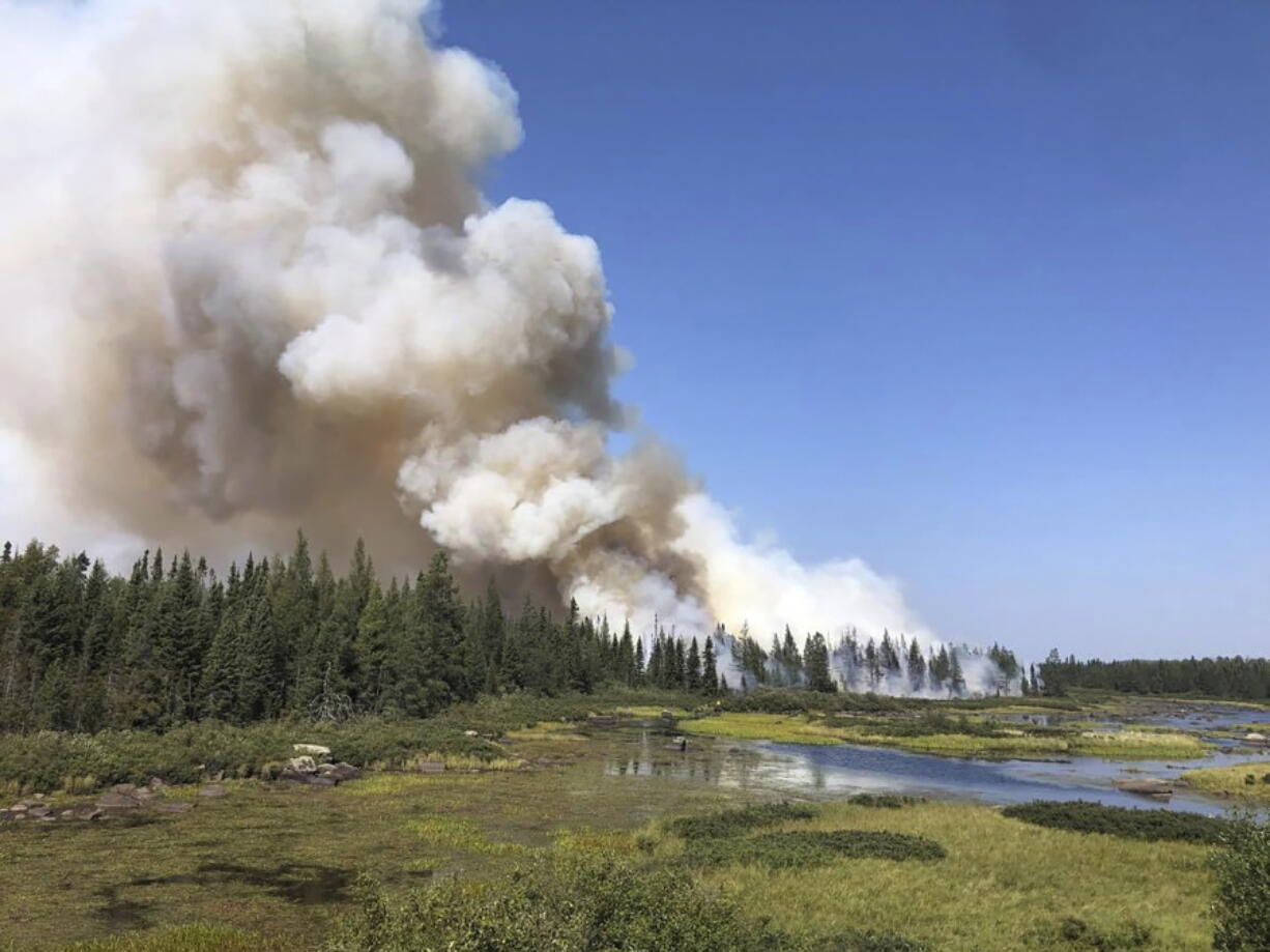 In this photo provided by the United States Forest Service, smoke billows during a defensive burn-out operation, Sunday, Aug. 22, 2021, on the southeastern edge of the Greenwood Lake wildfire in the Superior National Forest of northeastern Minnesota, which has burned more than 14 square miles. The purpose was to decrease the amount of natural fuels available to threaten the containment line.