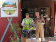 Andra and John Spencer show a recent harvest of fruit from their Washougal Get To-Gather retail farm stand.