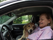 Margie Bauer of Harper Woods, Mich., cuddles her dog Liberty inside her 2015 Chevy Equinox on Aug. 22. Bauer bought the vehicle because two dogs could easily fit in the back seat.