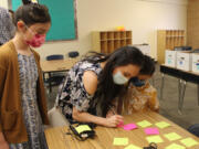 Fernanda Titcomb, center, attends a back-to-school event for Camas Connect Academy on Aug. 24 with her children, Anela, left, and Santiago. Titcomb said safety concerns related to the COVID-19 pandemic prompted her family to enroll in the district's remote school.