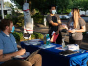 Michael Chu and Sandy Nguyen of Renton visit a King County Public Health pop-up vaccination site together for a vaccine at Renton Library on Aug. 25, 2021. (Matt M.