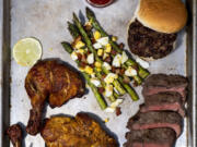 A tray of grilled delights; clockwise from top right, Cheeseburgers, Mustard-Lime Steak, Tandoori Chicken, and Grilled Asparagus With Olive Oil and Parmesan