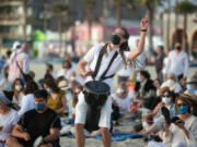 People take part in a Tashlich ceremony at Venice Beach on the first day of Rosh Hashanah on Wednesday, Sept. 8, 2021. High temperatures are forecast for Southern California through the weekend.