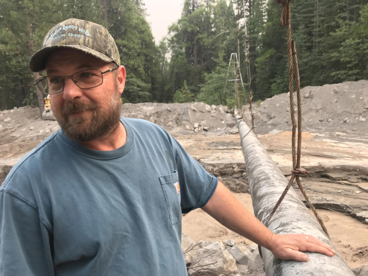 Richie Fesler, superintendent of public works for McCloud, a community of restored historic buildings on Shasta's southern flanks, is taking stock of progress made in an effort to remove tens of thousands of cubic yards of mud that nearly buried a suspended pipeline that supplied the area with spring water.