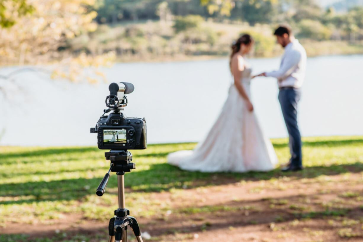 Filming Wedding Online - Social Distancing New Normal Concept live streaming - selective focus on the camera