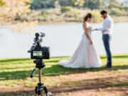 Filming Wedding Online - Social Distancing New Normal Concept live streaming - selective focus on the camera