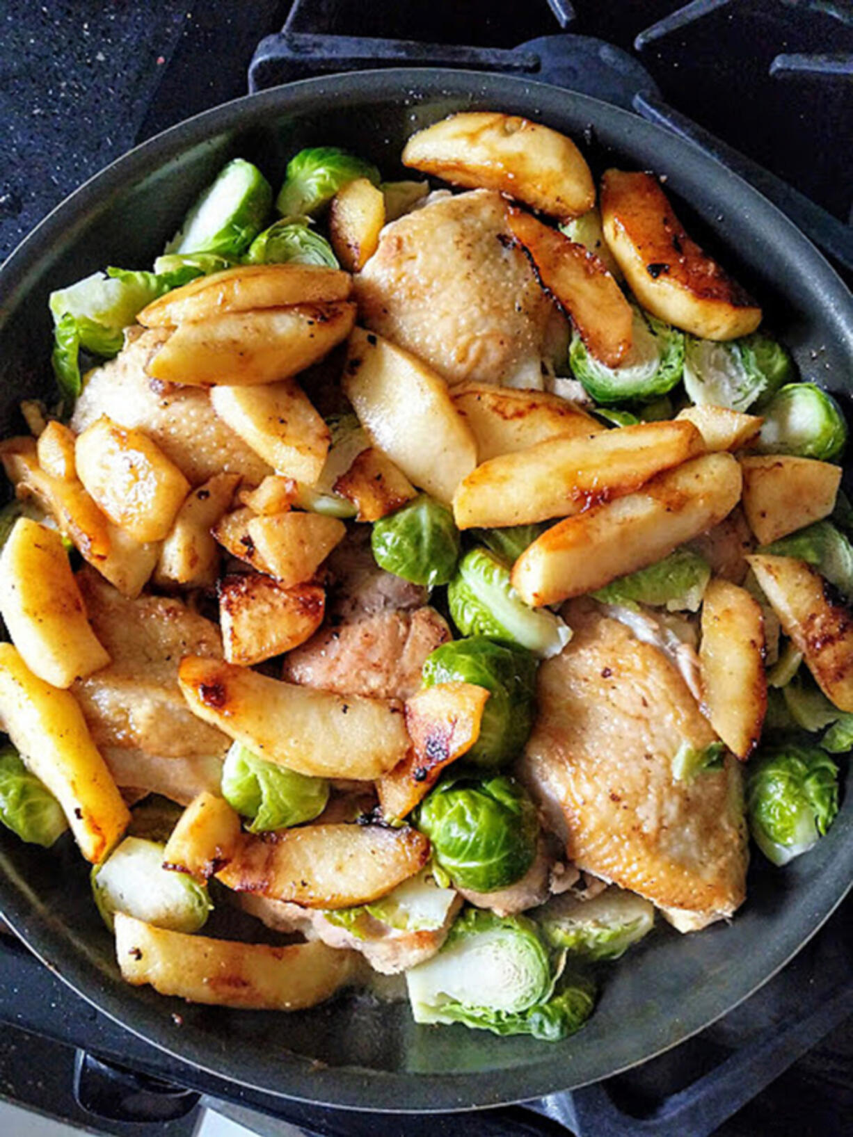 Chicken thighs braised in hard cider with Brussels sprouts and apples makes an easy one-pan fall dinner.