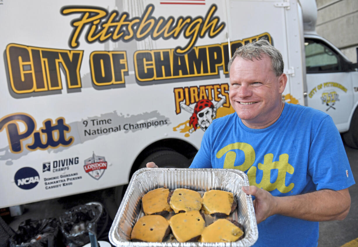 John Dusch displays his burgers Sept. 4 in front of his Mobile Tailgating Unit in the parking lot before Pitt takes on University of Massachusetts at Heinz Field in Pittsburgh.