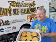 John Dusch displays his burgers Sept. 4 in front of his Mobile Tailgating Unit in the parking lot before Pitt takes on University of Massachusetts at Heinz Field in Pittsburgh.