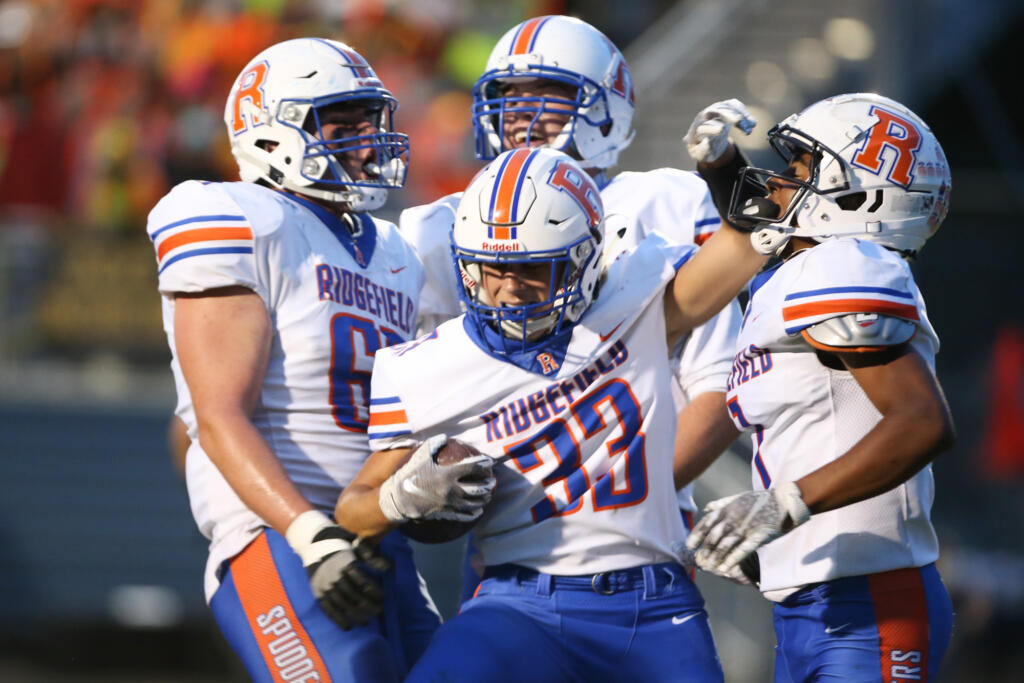 Ridgefield Spudders Davis Pankow (33) celebrates a first half score with teammates in the first half against the Hockinson Hawks in the 2A Greater St. Helens League season opener for both teams at Hockinson High School on Friday, Sept. 17, 2021. (Randy L.