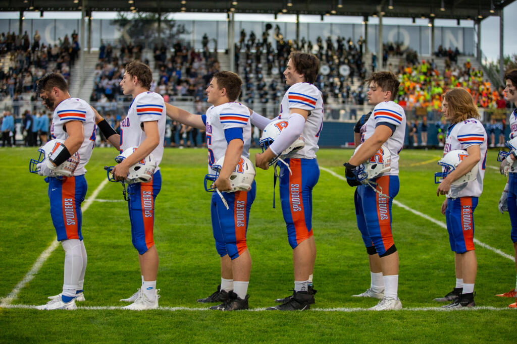 Ridgefield Spudders players in opening ceremonies against the Hockinson Hawks in the 2A Greater St. Helens League season opener for both teams at Hockinson High School on Friday, Sept. 17, 2021. (Randy L.