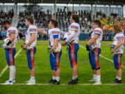 Ridgefield Spudders players in opening ceremonies against the Hockinson Hawks in the 2A Greater St. Helens League season opener for both teams at Hockinson High School on Friday, Sept. 17, 2021. (Randy L.