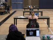 Students work in the "Internet Cafe" on Tuesday, Jan. 26, 2021, at Captain Strong Primary School in Battle Ground. Students are set up with Chromebooks in the gymnasium if they need internet to access remote learning.