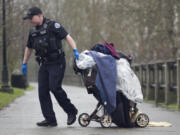 Officer Brian Ruder hauls away a load of debris left by houseless people along the Columbia River in 2015. The Vancouver City Council passed an ordinance Monday night allowing camping during the day for nighttime-working houseless people, and also to begin the process of selecting "supportive campsites" around the city.