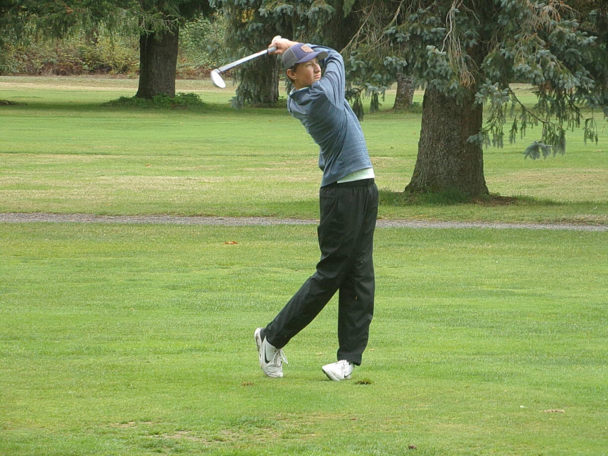 Woodland's Dane Huddleston hits his approach shot on No. 16 at Lewis River during the Prairie Invitational on Wednesday, Sept.