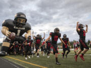 Papermakers enter the field for the Camas football home opener game against the Clackamas Cavaliers at Doc Harris Stadium on Friday, September 10, 2021.