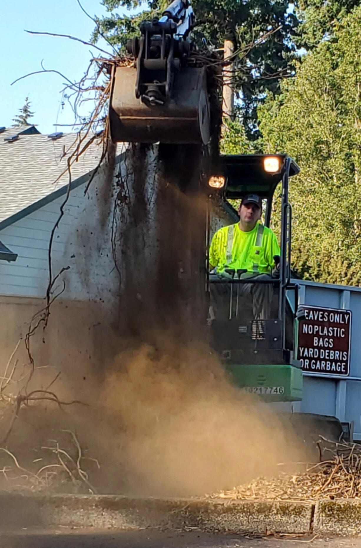 Volunteer Tom Denman uses a three-ton excavator to clear an area that will be transformed into a native plant oasis in Vancouver's Riveridge neighborhood Aug. 29.