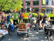 Members of the Vancouver Bike Club prepare to depart from the Vancouver Farmers Market withy a load of donated food bound for the Clark County food Bank. On most Sundays, club members gather at the downtown Vancouver event to pick up donations, which benefit the food bank and its partner agencies.